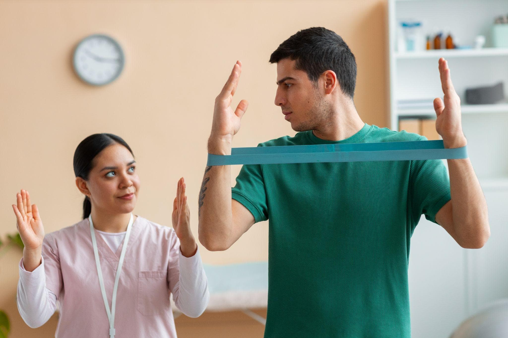 Therapist demonstrating for the patient the bracing therapy for the arms, and the patient copying the therapist.