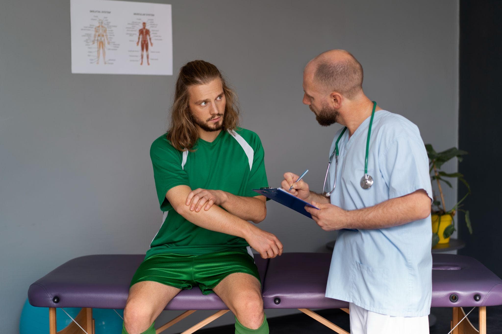 Athlete consulting a physiotherapist for arm injury in a clinic.