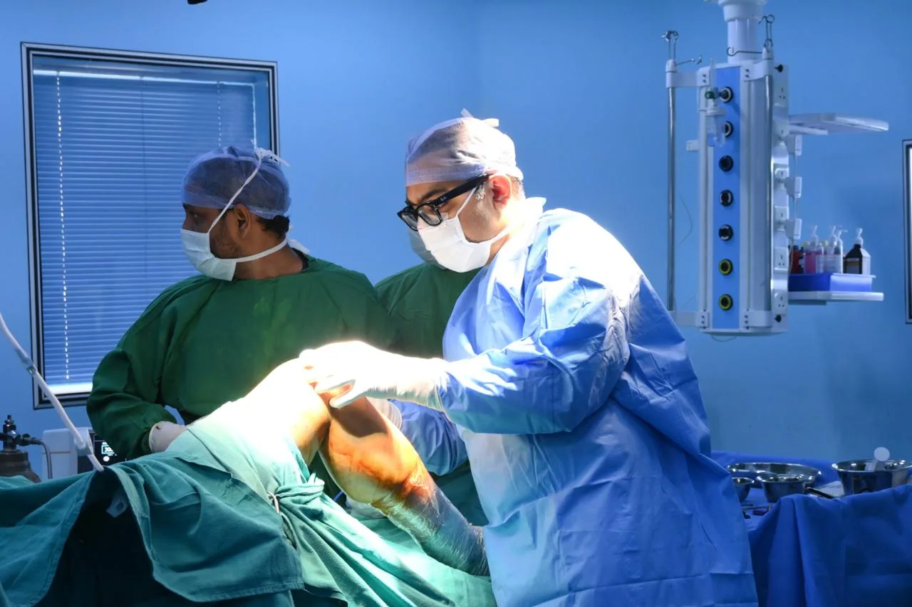 Robotic knee replacement surgery using advanced robotic arm technology.