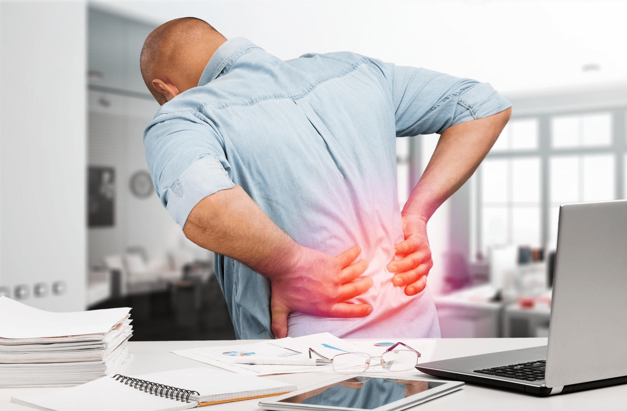 Man suffering from lower back pain due to slip disc.