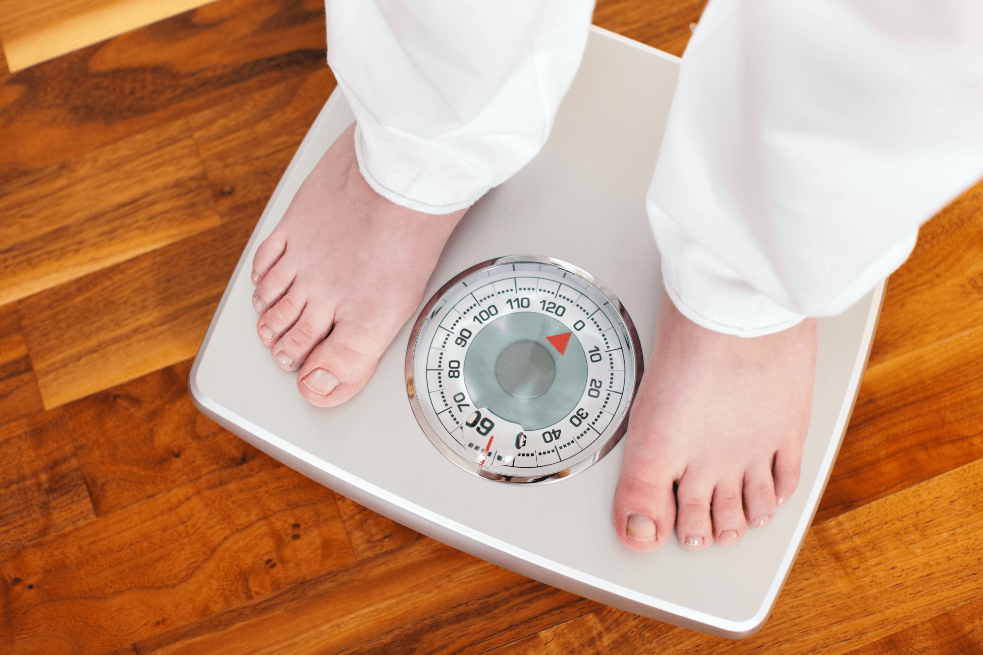 A man standing on weighing scale.